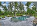 Relaxing backyard pool area, lush landscaping, lounge chairs, and a serene setting make this space inviting at 562 Preservation Dr, Fort Mill, SC 29715