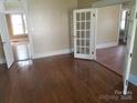 Open concept living room boasts hardwood floors, fresh paint, and lots of natural light at 607 Lee Ave, Wadesboro, NC 28170