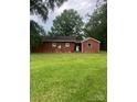 A cozy brick home nestled in a lush, green backyard, perfect for relaxation and outdoor enjoyment at 610 E Maryland Ave, Bessemer City, NC 28016