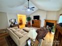 Bright living room showcasing hardwood floors, a fireplace, and an open floor plan leading to the dining area at 675 Godbey Rd, Salisbury, NC 28147