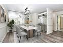 Stylish dining room with modern light fixture, decorative mirror, and a serving bar area at 7123 Meeting St, Charlotte, NC 28210