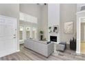 Bright living room featuring a tall fireplace, large windows, and neutral decor at 7123 Meeting St, Charlotte, NC 28210