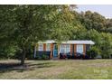 Charming single-story home with mature trees and a well-maintained front yard at 728 Morningside Dr, Mount Holly, NC 28120