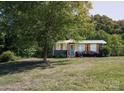 Charming single-story home with mature trees and a well-maintained front yard at 728 Morningside Dr, Mount Holly, NC 28120