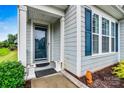 Home's front door features a glass panel with white trim and matching side windows at 7362 Overjoyed Xing, Charlotte, NC 28215
