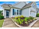 Close up of the entry and garden of this beautiful home, highlighting the sidewalk access at 7362 Overjoyed Xing, Charlotte, NC 28215