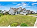 Charming one-story home with lush front yard, blue shutters, and an attached two-car garage at 7362 Overjoyed Xing, Charlotte, NC 28215