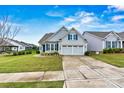 Inviting single-Gathering home featuring a well-manicured lawn and a two-car garage with a concrete driveway at 7362 Overjoyed Xing, Charlotte, NC 28215