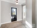 Inviting entryway features light wood floors and a black front door with glass panel at 7513 Lancaster Hwy # 6, Waxhaw, NC 28173