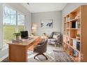 Bright home office with a large window, built-in bookshelf, and modern decor at 7513 Lancaster Hwy # 6, Waxhaw, NC 28173