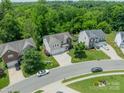An aerial view showcases a desirable neighborhood with tree-lined streets and well-maintained homes at 7650 W Berkeley Rd, Denver, NC 28037