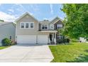 A charming two-story home with a well-manicured lawn and a two-car garage and brick accents at 7650 W Berkeley Rd, Denver, NC 28037