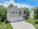 Charming two-story home featuring a two-car garage, brick accents, and a well-manicured lawn at 7650 W Berkeley Rd, Denver, NC 28037