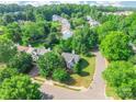An aerial view of the property nestled in a neighborhood with mature trees and well-maintained lawns at 8339 Hornwood Ct, Charlotte, NC 28215