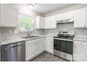 The kitchen boasts stainless steel appliances, white cabinets, and marble-look countertops at 8339 Hornwood Ct, Charlotte, NC 28215