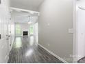 Spacious living room showcasing stylish wood floors, fireplace, and abundant natural light at 8339 Hornwood Ct, Charlotte, NC 28215