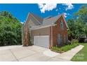 Charming home featuring brick and siding exterior, two-car garage, and well-maintained landscaping at 8914 Landsdowne Ave, Harrisburg, NC 28075