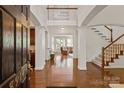 Grand foyer with hardwood floors, soaring ceilings, and an open staircase to the second level at 8914 Landsdowne Ave, Harrisburg, NC 28075