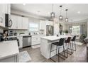 Bright kitchen with white cabinetry, stainless steel appliances, and a quartz-topped island at 9034 Evercrisp Ln, Charlotte, NC 28215