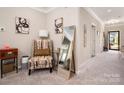 Cozy living room featuring stylish chair, modern art, and a full length mirror at 9034 Evercrisp Ln, Charlotte, NC 28215
