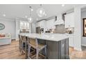Elegant kitchen with a large island, pendant lighting, stainless steel appliances, and white cabinetry at 9109 Liberty Hill Dr, Mint Hill, NC 28227