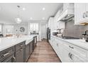 Modern kitchen featuring an island, stainless steel appliances, and sleek white cabinets at 9109 Liberty Hill Dr, Mint Hill, NC 28227