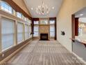 Bright living room with tall windows, fireplace, and open layout for easy entertaining at 1000 Sarandon Dr, Matthews, NC 28104