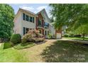 Charming exterior view of a two-story home with a brick and siding facade and landscaped front yard at 1147 Anduin Falls Dr, Charlotte, NC 28269