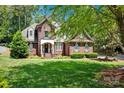Traditional two-story home with a lush green lawn and mature trees offering ample shade at 117 Lake Hills Dr, Mooresville, NC 28117