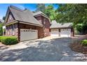 Spacious three-car garage with ample parking space and brick exterior at 117 Lake Hills Dr, Mooresville, NC 28117