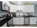 Modern kitchen boasts white cabinets, stainless steel appliances, dark countertops and a stylish subway tile backsplash at 1215 Cardinal Dr # 9, Gastonia, NC 28052