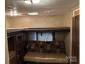 Cozy living room with overhead bunk; great for relaxing after a long day at 131 Twin Bluff Trl, Mount Gilead, NC 27306