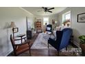Bright living room features hardwood floors, neutral walls, large windows and stylish furnishings at 134 Snowbird Loop, Statesville, NC 28625