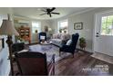 Inviting living room features hardwood floors, neutral walls, large windows and elegant furnishings at 134 Snowbird Loop, Statesville, NC 28625