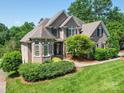 Stunning brick home features lush landscaping and a welcoming front entrance at 1508 Avalon Oaks Ct, Dallas, NC 28034