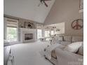 Bright living room with fireplace, vaulted ceiling, and ample natural light at 1508 Avalon Oaks Ct, Dallas, NC 28034