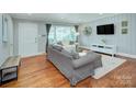 Bright living room with large windows, hardwood floors and neutral decor at 1715 Wensley Dr, Charlotte, NC 28210