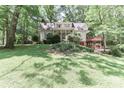Beautiful home with a well-manicured lawn and mature trees, offering a serene and private setting at 173 Rocky River Rd, Mooresville, NC 28115