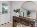 Entryway with a wood console table, gold mirror, vase with greenery and front door at 1746 2Nd Street Sw Pl, Hickory, NC 28602