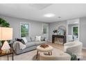 Bright living room featuring a gray sofa, round ottoman, and stylish decor at 1746 2Nd Street Sw Pl, Hickory, NC 28602