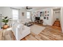 Bright and airy living room featuring hardwood floors, comfortable white furniture, and stylish decor at 1817 Rush Wind Dr, Charlotte, NC 28206