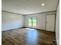 Inviting living room featuring wood-look flooring, neutral walls, and natural light from windows at 188 Trivette Rd, Harmony, NC 28634