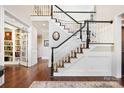 Elegant foyer showcasing a staircase with dark wood and white railings and hardwood flooring at 19946 River Falls Dr, Davidson, NC 28036