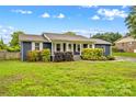 Charming single story home with well-maintained landscaping, blue siding, and white trim at 211 Ridgecrest St, Kannapolis, NC 28081