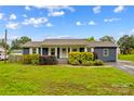 Charming single story home with well-maintained landscaping, blue siding, and white trim at 211 Ridgecrest St, Kannapolis, NC 28081