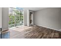 Sunlit living room featuring hardwood floors and a large window at 415 W 7Th St # H, Charlotte, NC 28202