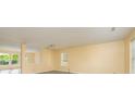 Bright living room with neutral walls, gray wood-look flooring, and a large window at 4521 Palustris Ct, Charlotte, NC 28269