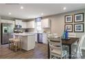 Bright kitchen featuring white cabinets, stainless steel appliances, a center island and a dining area at 577 Nesbe St # 2222, Lancaster, SC 29720