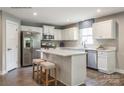 Bright kitchen featuring white cabinets, stainless steel appliances, and a center island with seating at 577 Nesbe St # 2222, Lancaster, SC 29720