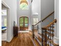 Grand foyer boasts hardwood floors, high ceilings, a staircase, and a view of the front door at 6211 Cruden Bay Way, Charlotte, NC 28277
